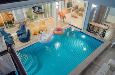 Indoor swimming pool with lounge area in a luxurious home