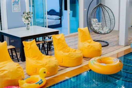Indoor swimming pool area with lounge chairs and playful decorations