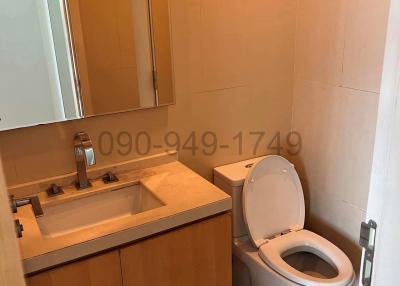 Modern bathroom with wooden vanity and mirror