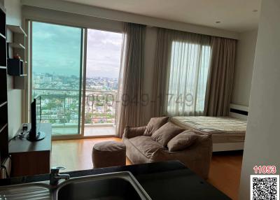 Modern bedroom with large windows and city view