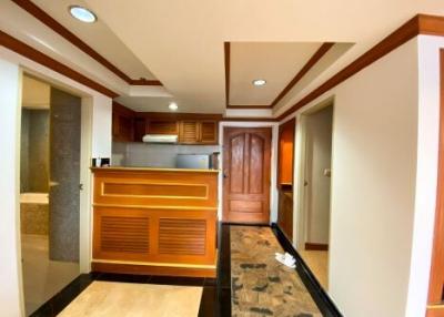 Modern kitchen interior with wooden finishes and marble flooring