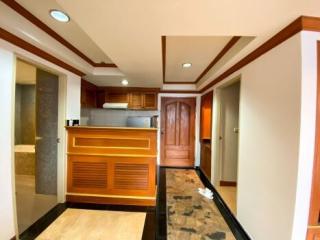 Modern kitchen interior with wooden finishes and marble flooring