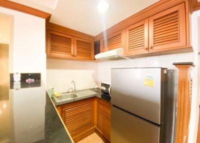 Modern kitchen with wooden cabinets and stainless steel appliances