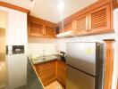 Modern kitchen with wooden cabinets and stainless steel appliances