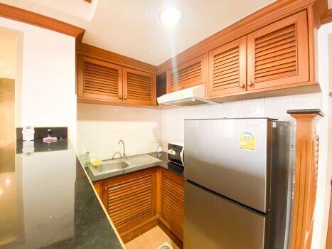 Modern kitchen with wooden cabinets and stainless steel appliances