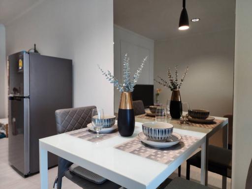 Modern dining area with table set for meal