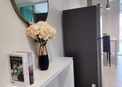 Modern hallway interior with decorative mirror and flowers