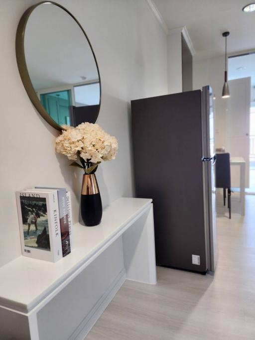 Modern hallway interior with decorative mirror and flowers