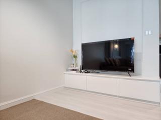 Minimalist living room with television and modern white cabinets