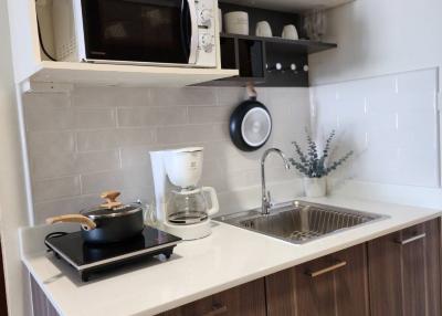 Modern kitchen with wooden cabinets and stainless steel appliances