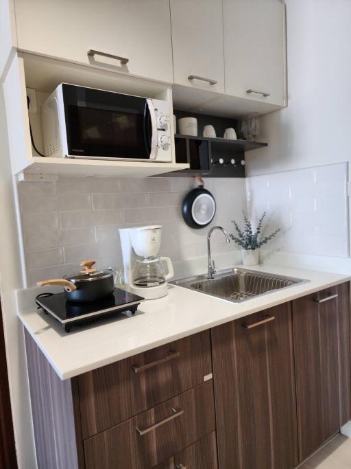 Modern kitchen with wooden cabinets and stainless steel appliances