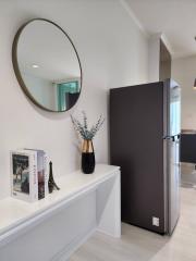 Modern hallway interior with refrigerator and decorative items