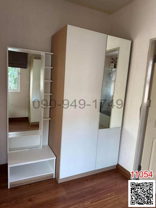 Compact bedroom with built-in wardrobe and mirror