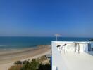 Beachfront balcony with panoramic sea view and outdoor furniture