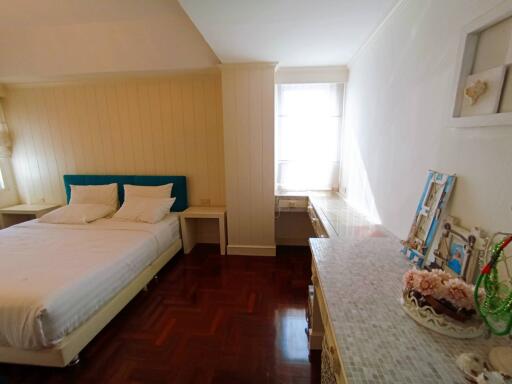 Cozy bedroom with wooden floor and natural light