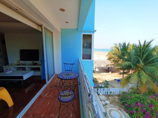 Spacious balcony with ocean view, outdoor seating, and proximity to nature