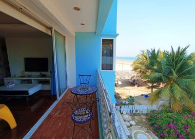 Spacious balcony with ocean view, outdoor seating, and proximity to nature