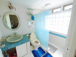 Bright bathroom with blue tile accents and natural light