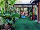 Cozy home patio with lush green plants and seating area
