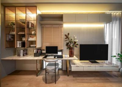 Modern home office with desk, shelves and television unit