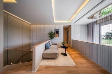 Modern living room with natural lighting, neutral tones, and comfortable seating