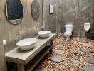 Modern rustic bathroom with natural stone floor and dual vessel sinks