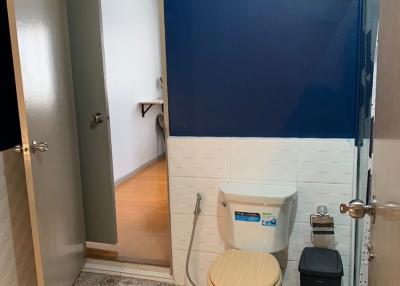 Compact bathroom with blue and white walls and patterned floor tiles