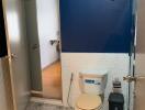 Compact bathroom with blue and white walls and patterned floor tiles