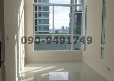 Bright and spacious empty living room with large windows and city view
