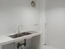 Modern white tiled kitchen with stainless steel sink