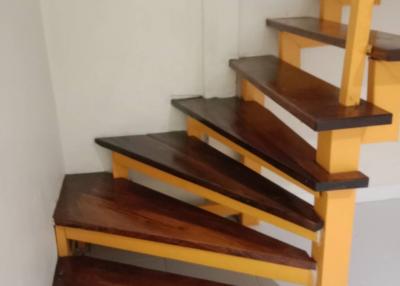 Wooden staircase with vibrant yellow railings