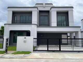 Modern two-story residential home with balcony and garage