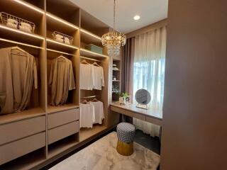 Elegant bedroom walk-in closet with custom shelving and natural light