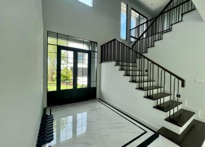Bright and modern entryway with staircase and large window