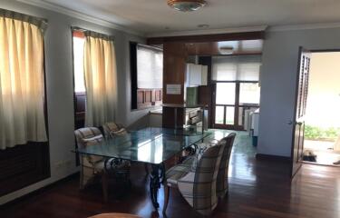 Spacious dining room with glass table and hardwood floors