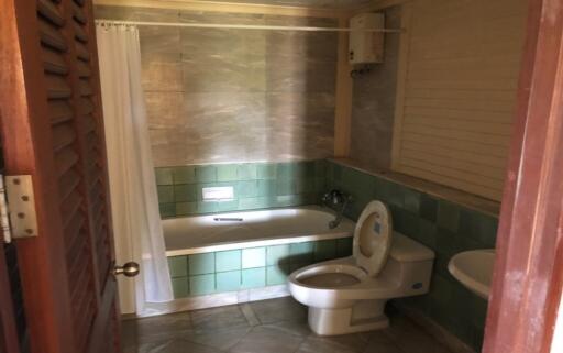 Spacious bathroom with tile flooring and tub