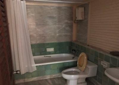 Compact bathroom with bathtub and toilet