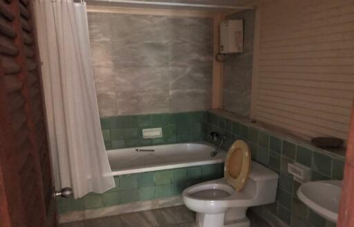 Compact bathroom with bathtub and toilet