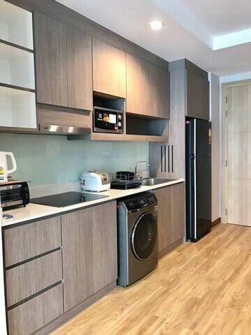 Modern kitchen with stainless steel appliances and wooden flooring