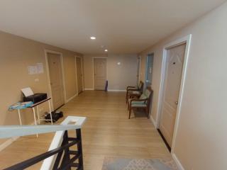 Spacious hallway with tiled flooring and multiple doors