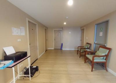 Spacious lobby with tiled flooring and multiple doors leading to other areas
