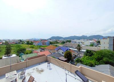 Expansive rooftop patio with a view of the surrounding cityscape and mountains