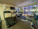 Home gym with treadmills and exercise equipment overlooking the street