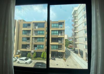 Window view of urban residential buildings and parking