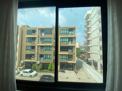 Window view of urban residential buildings and parking