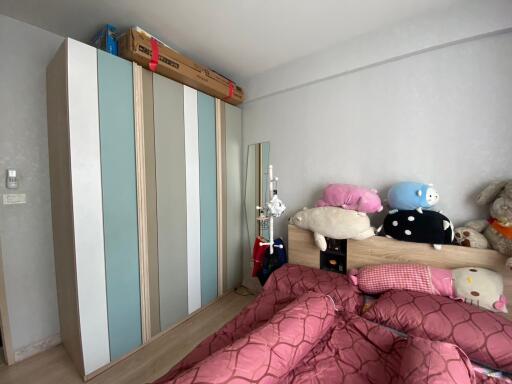 Cozy bedroom interior with wardrobe and plush toys