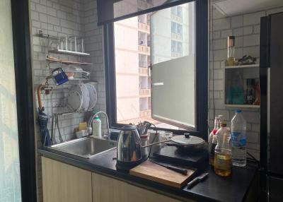 Modern kitchen with stainless steel appliances and large window