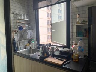 Modern kitchen with stainless steel appliances and large window