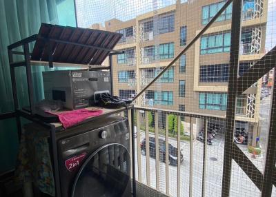 Apartment balcony with washing machine and safety net