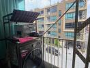 Apartment balcony with washing machine and safety net